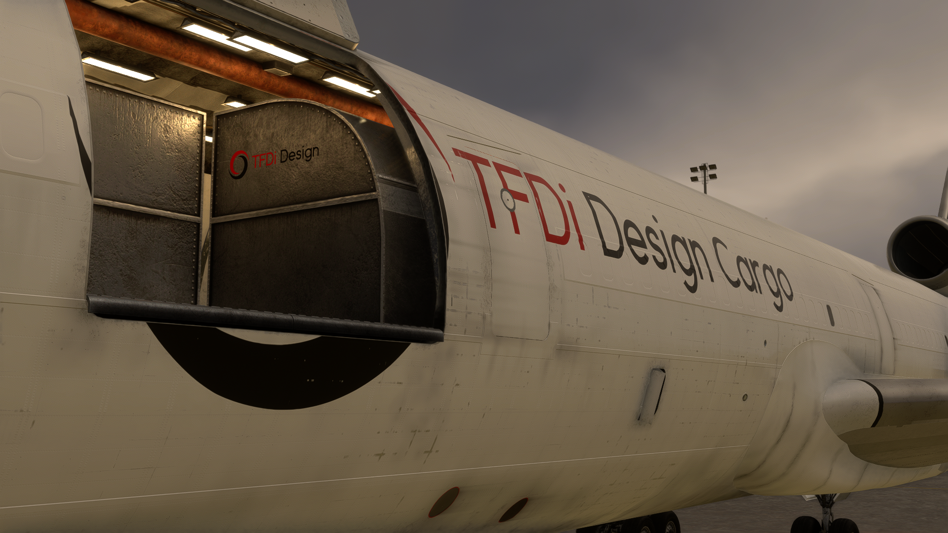 A mostly empty MD-11 cargo bay, with two pallets of cargo with the TFDi Design logo on their sides